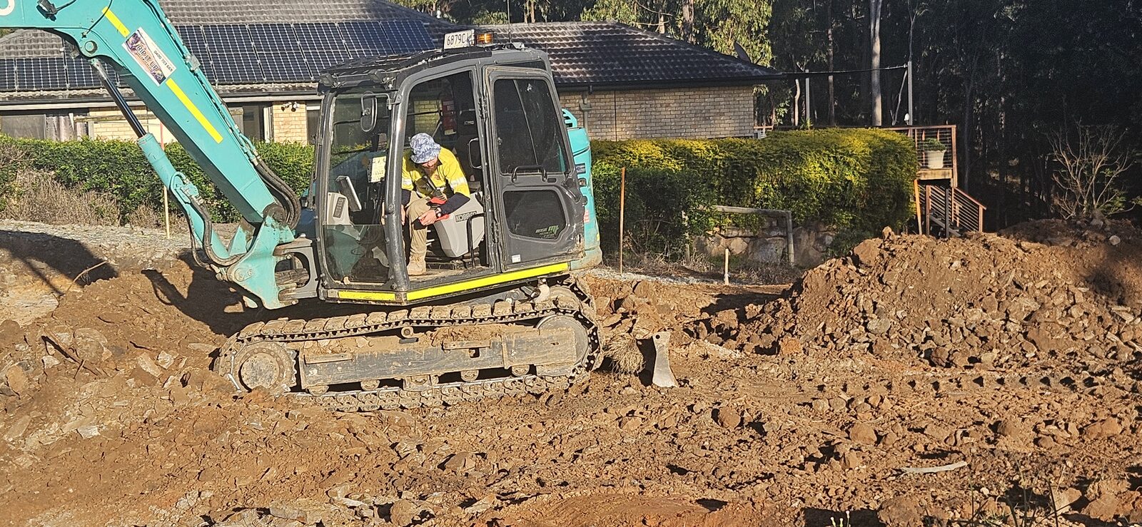 Sollid Solutions operator at the controls of the excavator on the dream home build