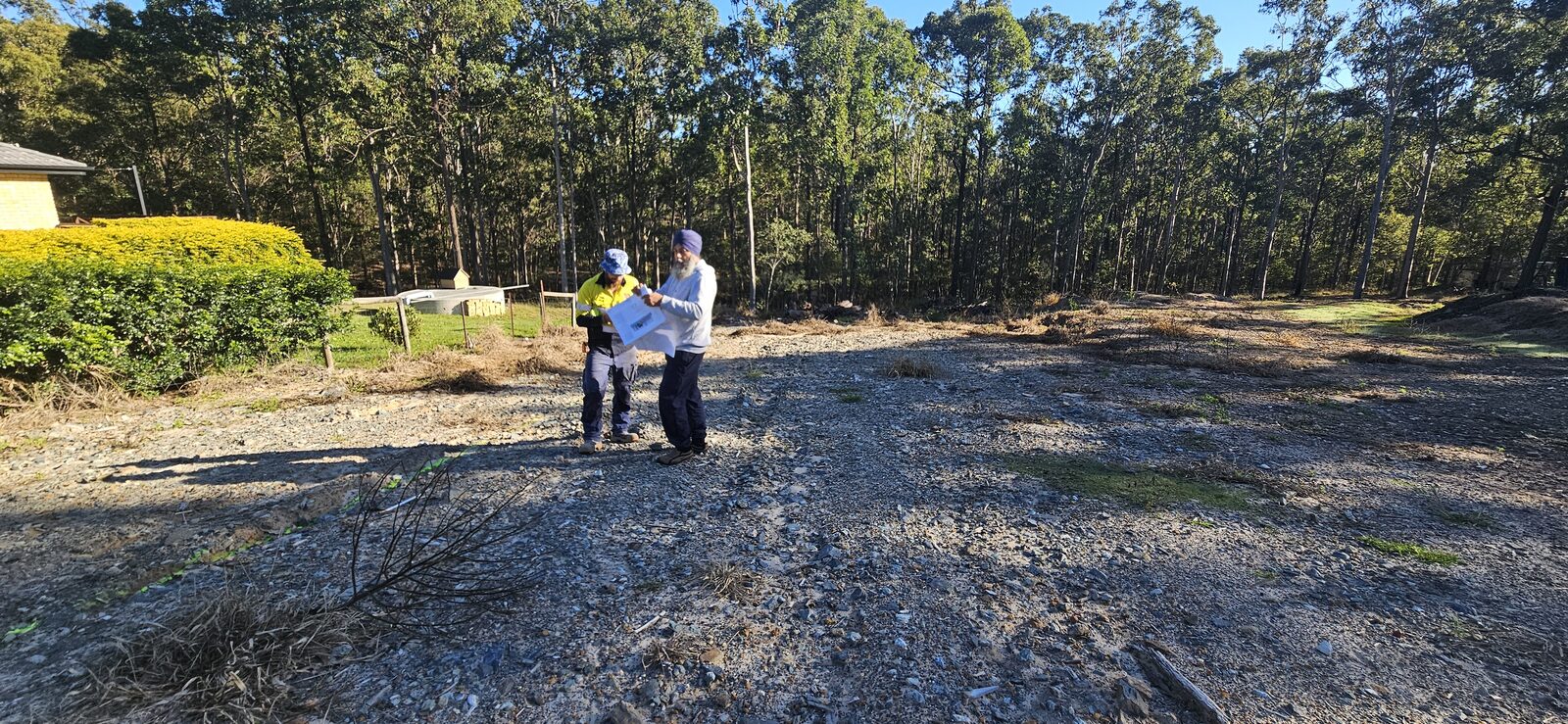 Sollid Solutions going over the house plans on the cleared block during the set-out
