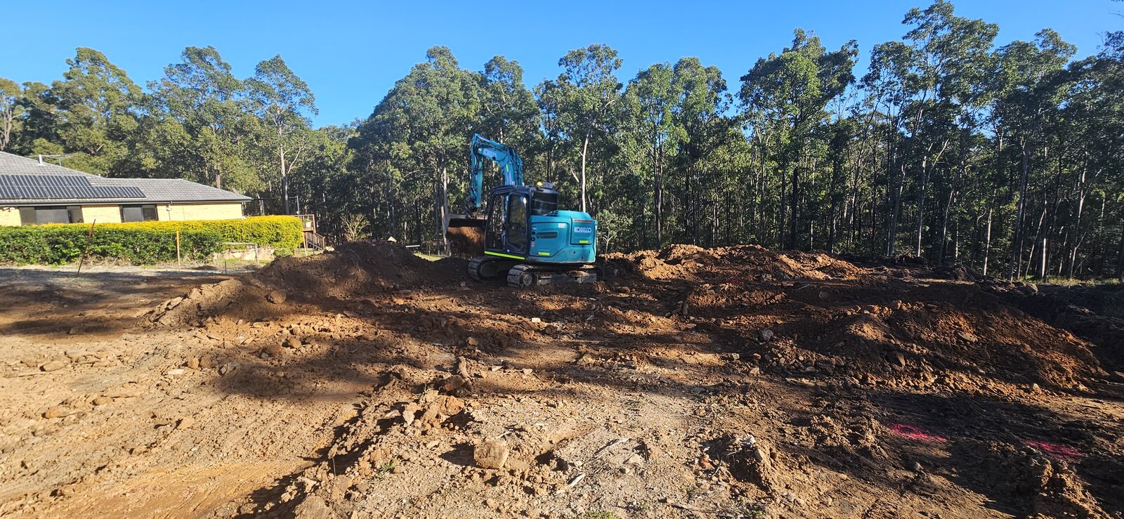 Excavator working across the block during the site cut for the new home, guest house and shed