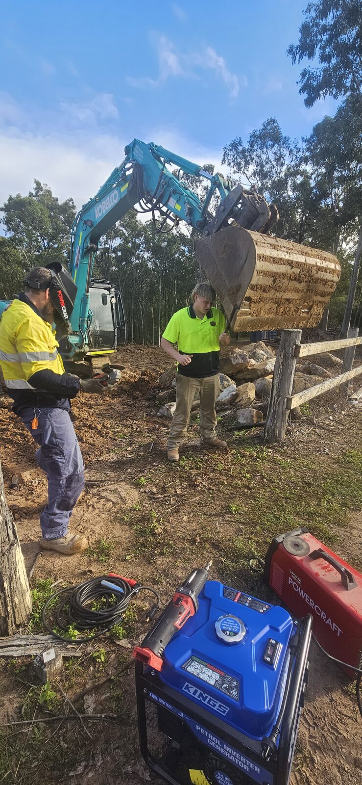 Generator and tools set up on site to repair the excavator bucket