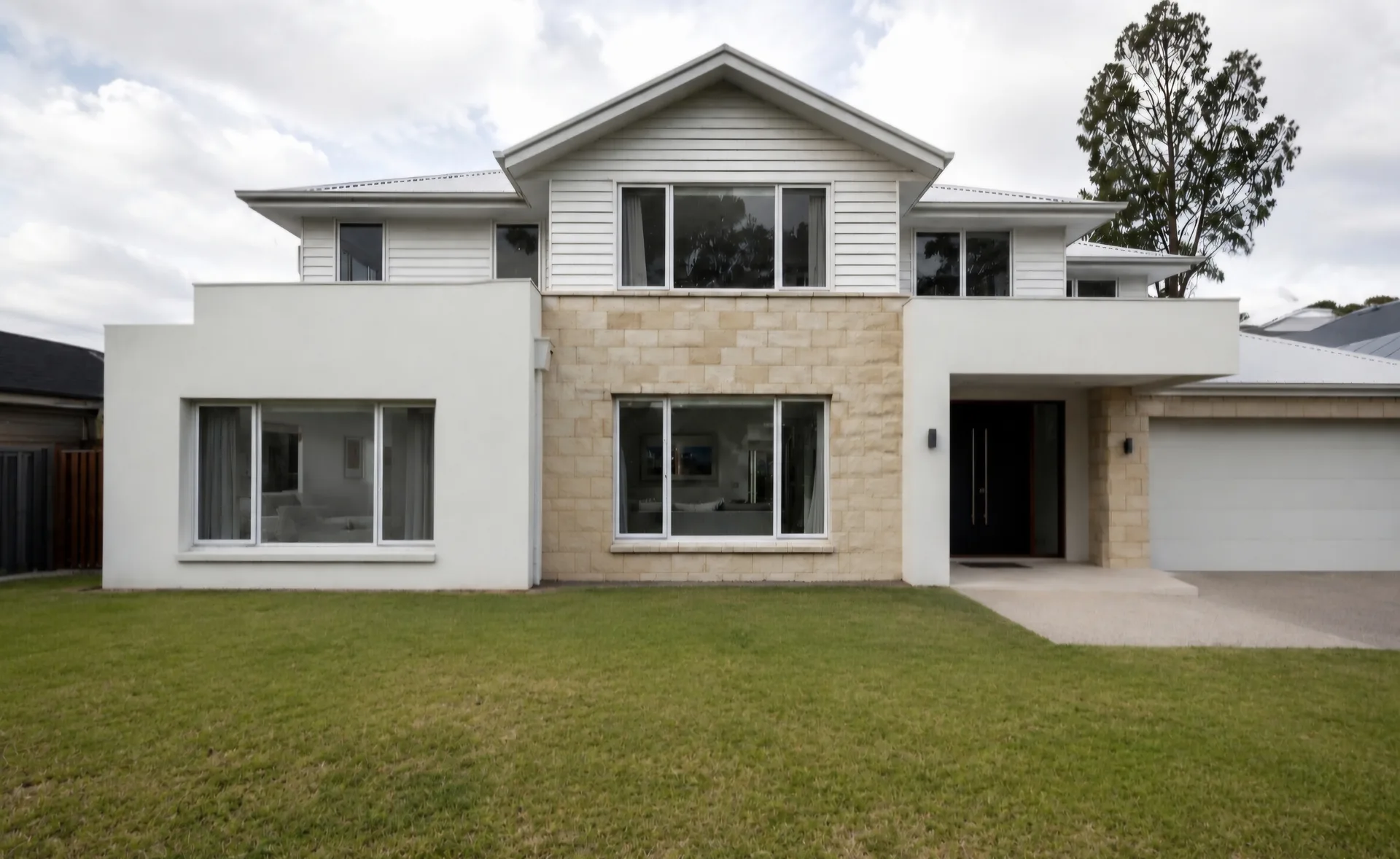 Front yard before landscaping — flat lawn with no plants on a modern Gold Coast home