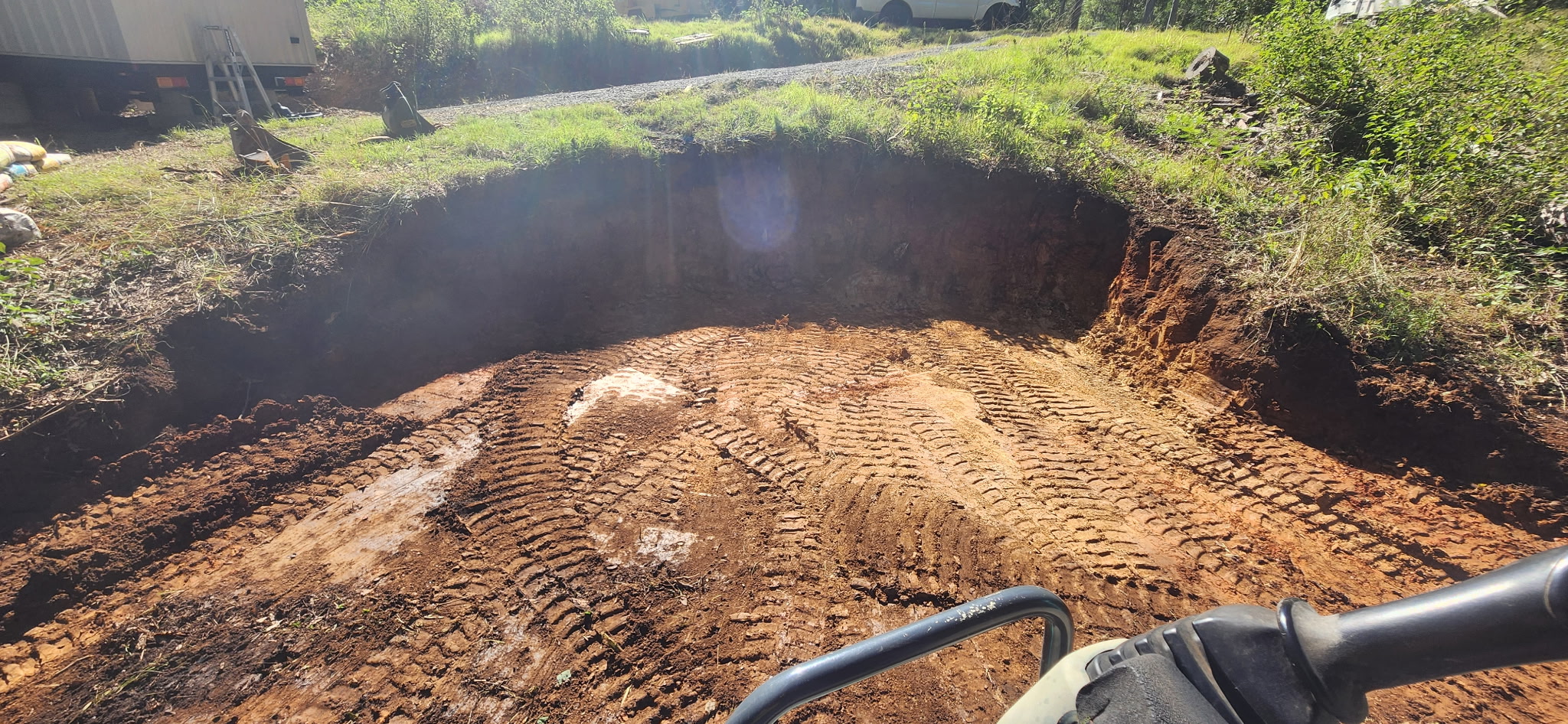 Start of the tank pad cut from inside the excavator cab