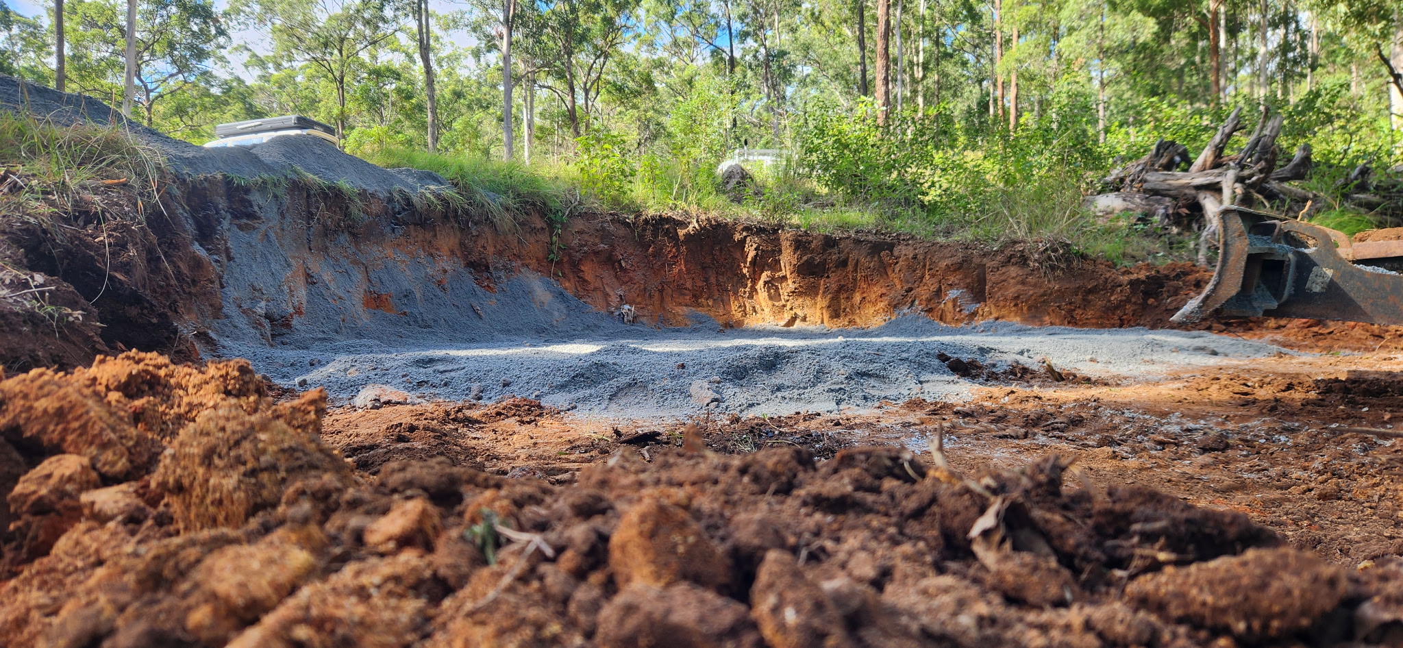 Low-angle view of finished tank pad with compacted road base